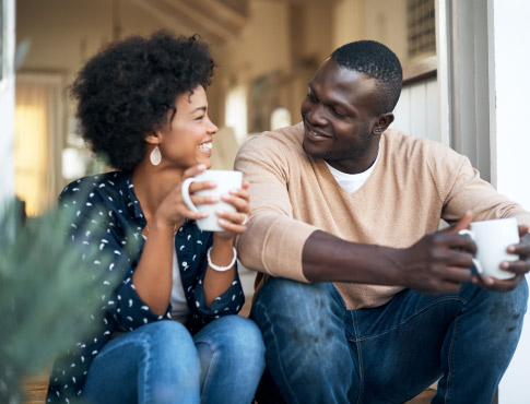 Couple drinking coffee and laughing