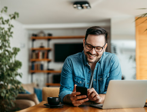 man smiling looking at phone